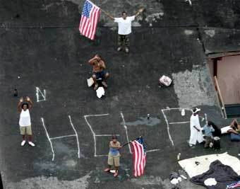 Жители затопленного Нового Орлеана просят о помощи на крыше одного из домов. Фото Reuters, 01 сентября 2005 года