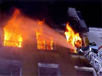 Пожарный тушит горящий дом в Париже. Фото Reuters, архив