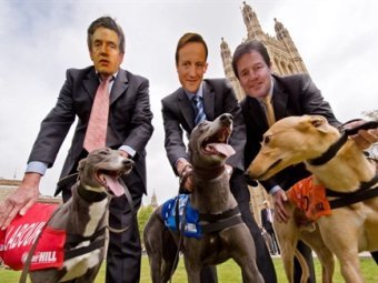 Люди в масках Гордона Брауна, Дэвида Кэмерона и Ника Клегга на собачьих бегах в Лондоне. Фото ©AFP